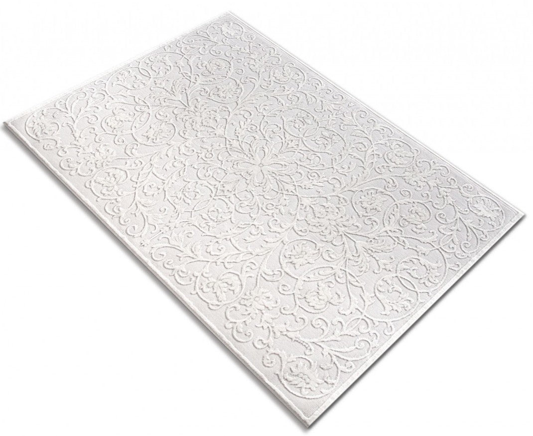 Covor alb modern asezat in decor de living, creeaza un ambient cald si confortabil