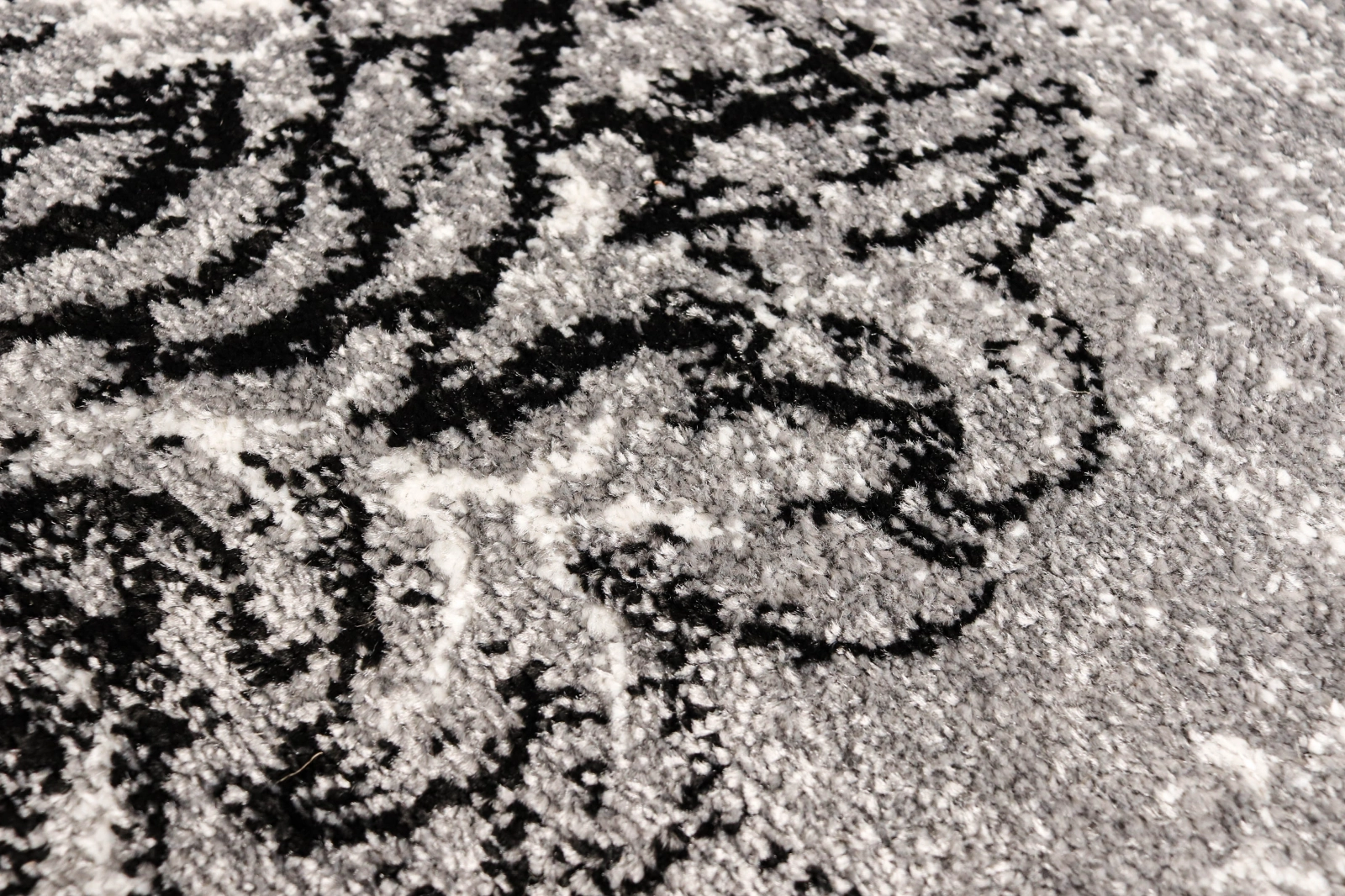 Detaliu covor oval gri textura fir scurt dens si durabil